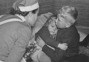World War 2 in Europe. A young woman from the Swedish Women's Voluntary Defence Organization tries to comfort the two young Finnish children Mauri and Marja Liisa Koski from Turku who have arrived in Stockholm
