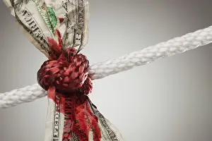 Wrinkled american dollar tied up and bleeding in rope