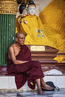 YANGON, MYANMAR, JANUARY 3, 2014: Ascetic Buddhist monk meditating in Shwedagon Paya pagoda