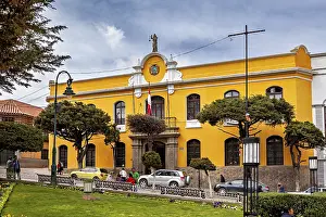 Yellow building with flags in an urban environment