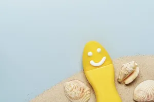 Yellow tube with happy sunscreen face