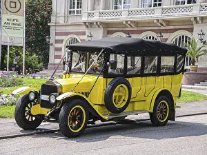 Yellow vintage bus in front of theatre