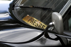 Yellowed press pass behind the windshield of a Citroen DS vintage car