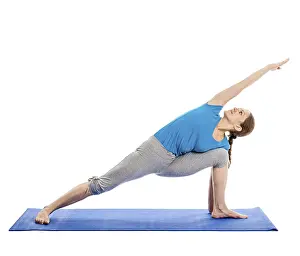 Yoga, young beautiful slender woman yoga instructor doing Extended Sides Angle Pose (Utthita Parsvakonasana)