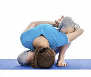 Yoga, young beautiful slender woman yoga instructor doing Forward Bends Sage Twist B pose (Marichyasana B)
