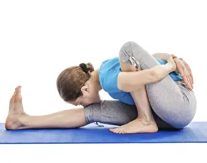 Yoga, young beautiful slender woman yoga instructor doing Forward Bends Sage Twist A pose (Marichyasana A)