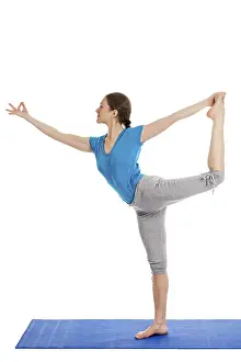 Yoga, young beautiful slender woman yoga instructor doing Lord of the Dance Pose (Natarajasana)