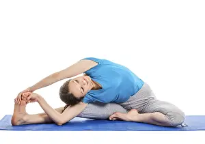 Yoga, young beautiful slender woman yoga instructor doing Revolved Head-to-Knee Pose (parivrtta janu sirsasana)