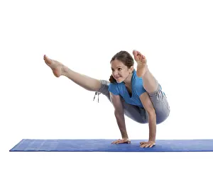 Yoga, young beautiful woman yoga instructor doing Firefly asana pose (Titibasana) exercise isolated on white background