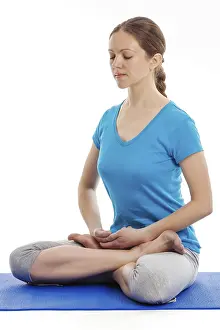 Yoga, young beautiful woman yoga instructor doing Lotus Position (padmasana with bhairava mudra) asana exercise