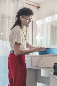 Young artist with a distinctive mullet haircut