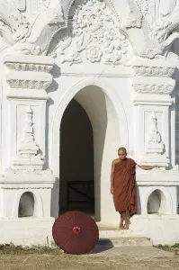 Young Buddhist monk in front of the Settawya Pagoda