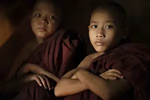 Young buddhist novice monk inside a temple background