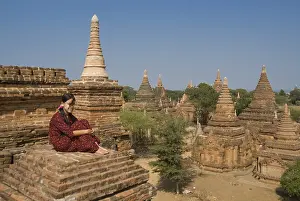Young Burmese woman on the roof of a temple