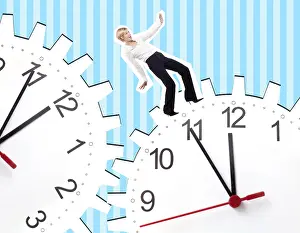 Young business woman between two clocks, composing