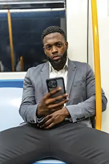 Young businessman commuting on a subway train
