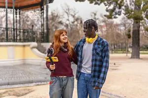 Two young content creators walking and talking in a park
