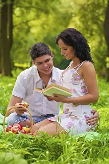Young couple sitting on grass in park