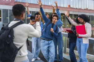 Young diverse students creating social media content together
