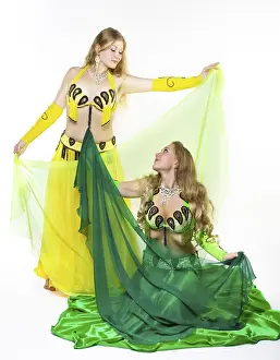 Two young girl dance with green veil