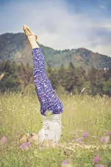 Young girl is doing yoga in the park