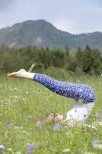 Young girl is doing yoga in the park