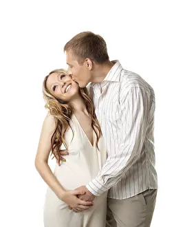 Young happy couple in white wait for baby
