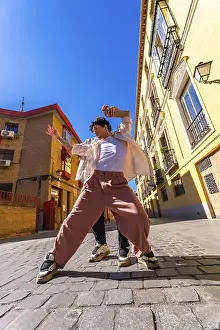 Young man actively dancing a contemporary urban street performance