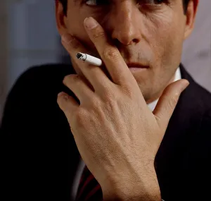 Young man with cigarette in mouth