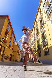 Framed Print : Young man dancer performing a dynamic street dance move in a vibrant old city urban setting under a clear blue sky