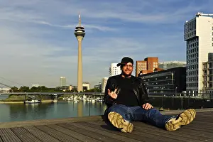 Young man gives the finger and laughs