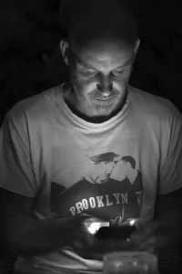 Young man on mobile phone at night
