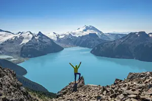 Young man standing on a rock, looking into the distance
