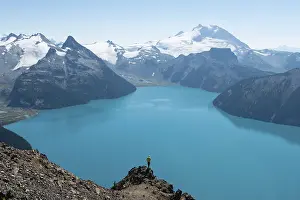 Young man standing on a rock, looking into the distance