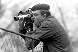 Young man taking pictures with a camera