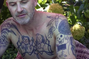 Young man with tattoos on arms and upper body