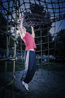 Young man by training at outdoor fitness facility