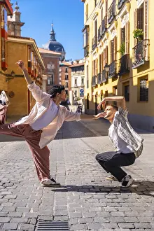 Framed Print : Two young men expressing emotion and movement through a modern dance routine on a cobblestone street Framed Print : Two young men expressing emotion and movement through a modern dance routine on a cobblestone street