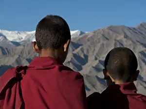 Two young monks looking across the Indus from the rooftop of Thikse Gompa