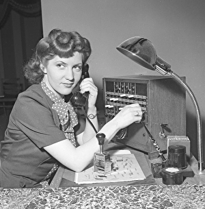 A young movie star-like woman works in the company's switchboard