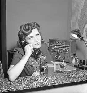 A young movie star-like woman works in the company's switchboard