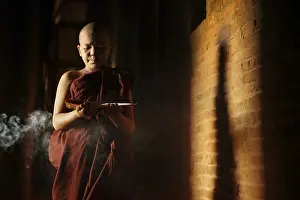 Young novice monk learning inside monastery