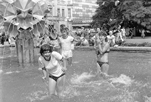 Young people bathing in a fountain