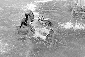 Young people bathing in a fountain
