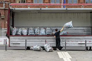 Young people collecting and loading plastic empties