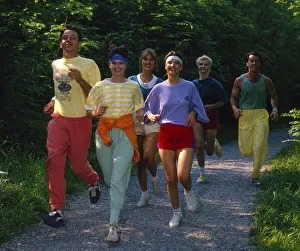 Young people jogging through flower meadow