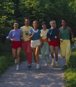 Young people jogging through flower meadow