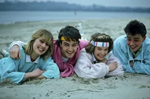 Young people lying on the beach 2 couples