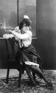 Young, pretty woman sitting on a chair smoking