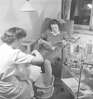 A young woman in a beauty salon gets a pedicure
